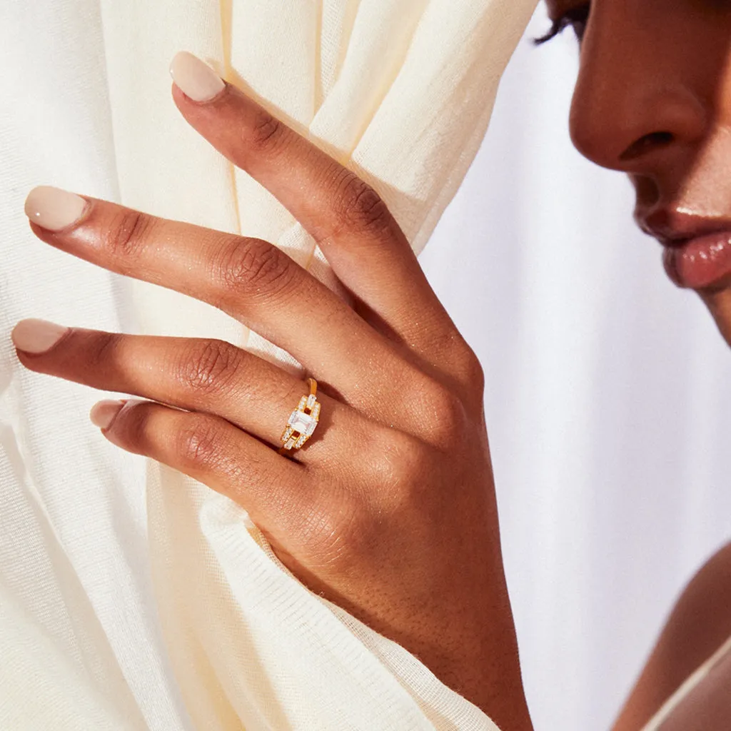 Emerald cut diamond buckle ring in yellow gold