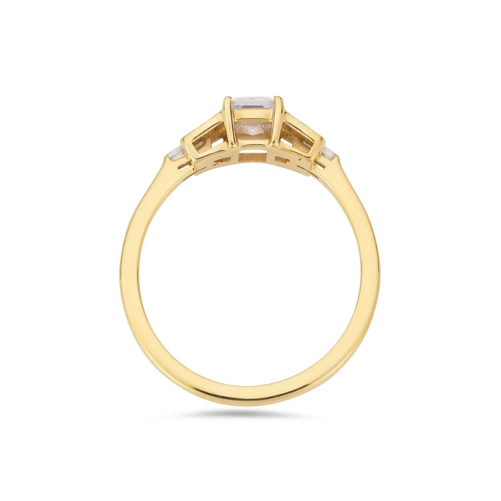 Emerald cut diamond buckle ring in yellow gold