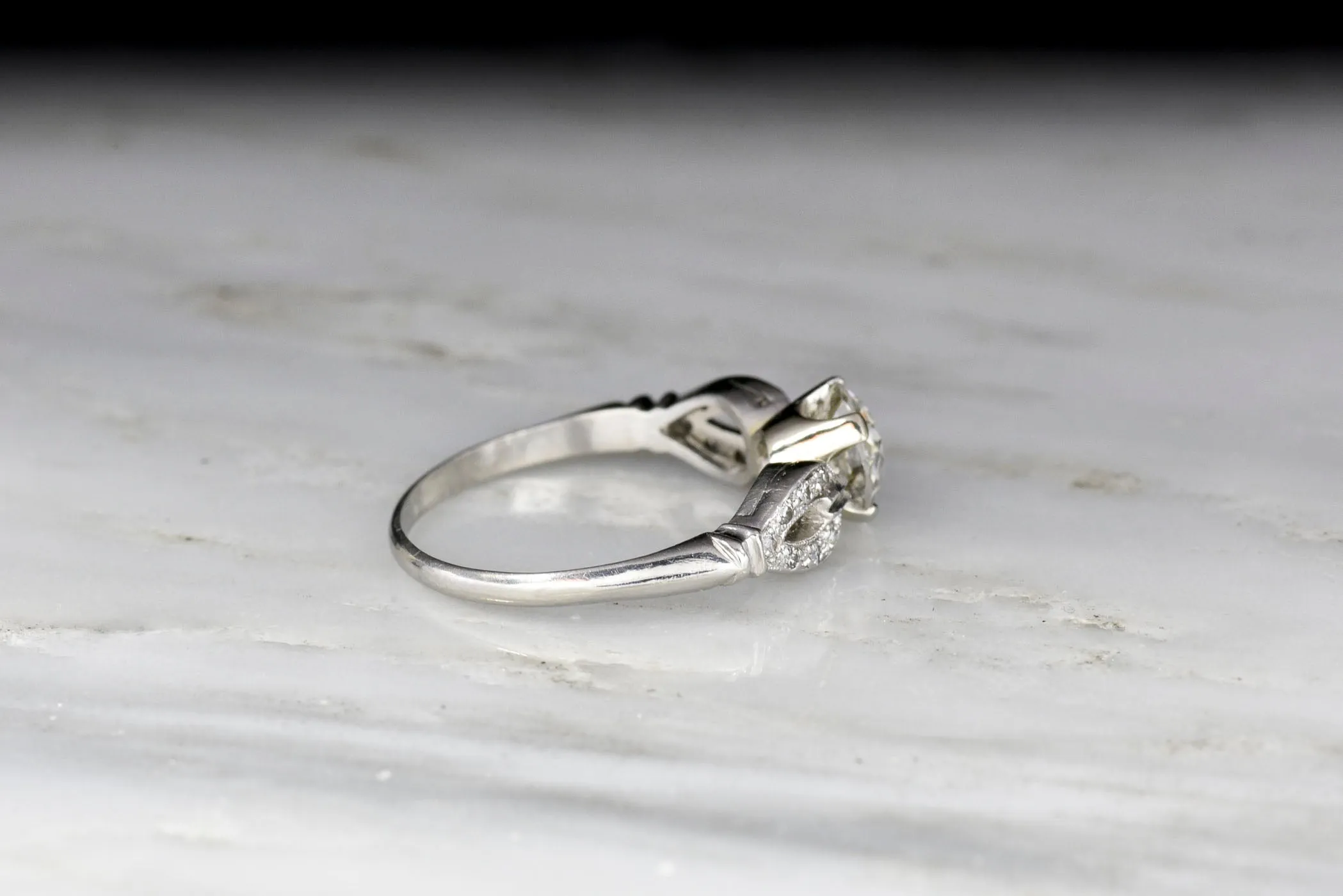 Late Art Deco/ Mid Century Platinum Engagement Ring with "Buckle-and-Clasp" Shoulders