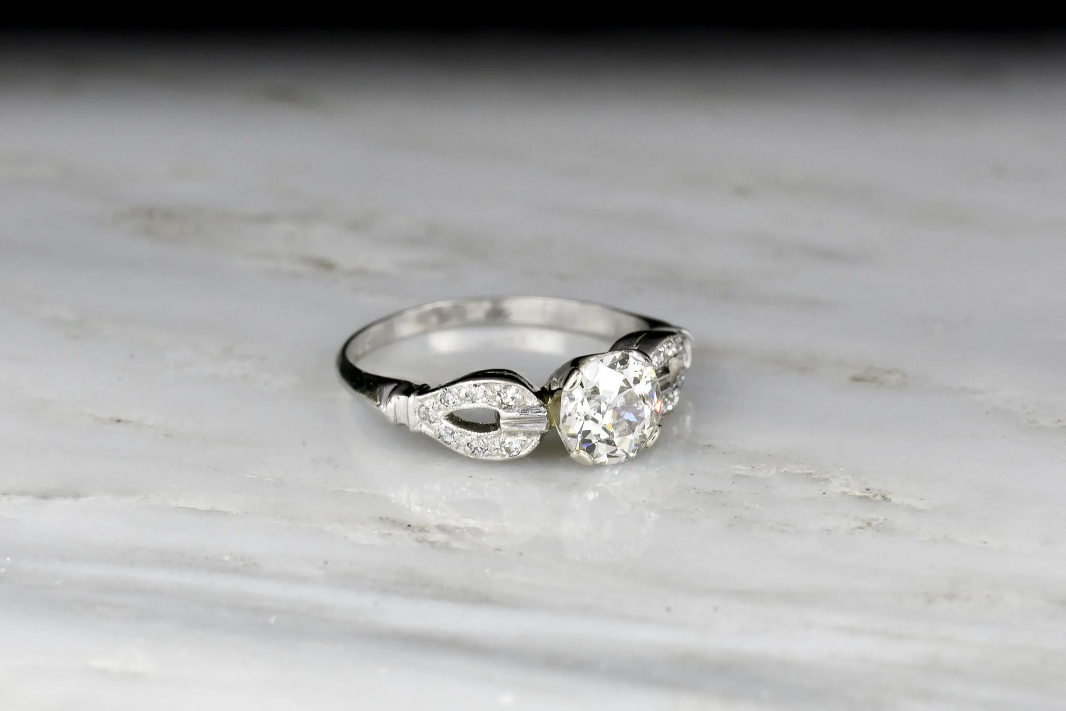 Late Art Deco/ Mid Century Platinum Engagement Ring with "Buckle-and-Clasp" Shoulders