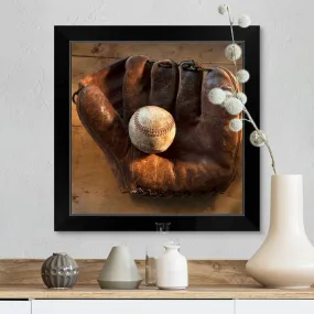 "Antique baseball on baseball glove with bat" Black Framed Print