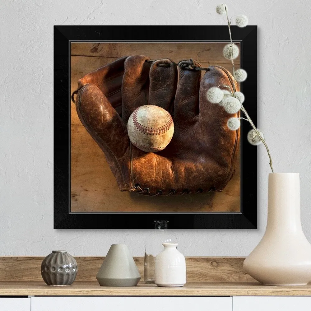 "Antique baseball on baseball glove with bat" Black Framed Print